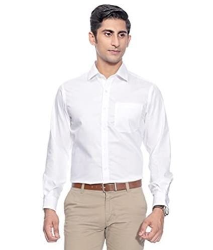 Man wearing a white formal shirt with beige trousers