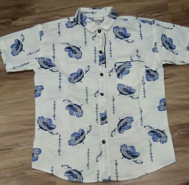 Half-sleeve floral printed shirt laid flat on a wooden floor