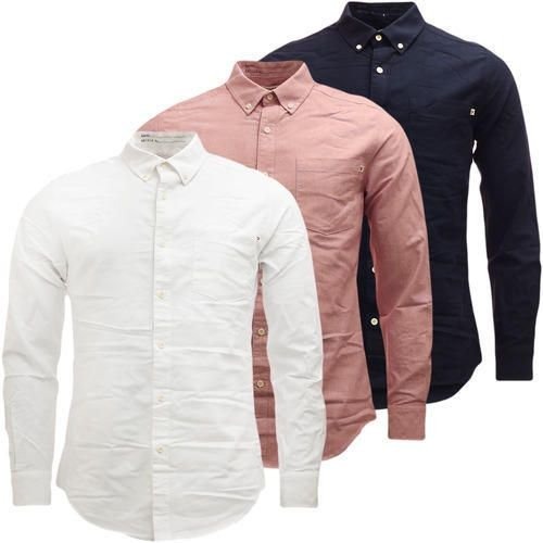 White, pink and navy plain men's shirts layered together